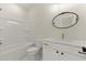 Bathroom featuring a white vanity, decorative mirror, and a tub at 4835 Fields Bridge Rd, Cumming, GA 30028