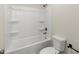 Bright bathroom with a white tub, shower, and toilet at 4835 Fields Bridge Rd, Cumming, GA 30028