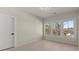 Bright bedroom featuring three large windows offering natural light and scenic views at 4835 Fields Bridge Rd, Cumming, GA 30028
