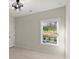 Bedroom featuring a modern ceiling fan with natural light and scenic views at 4835 Fields Bridge Rd, Cumming, GA 30028