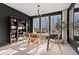 Bright dining room with modern light fixture and an abundance of light coming from the large windows at 4835 Fields Bridge Rd, Cumming, GA 30028