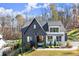 Charming two-story home with a combination of white and black siding and a well-manicured lawn at 4835 Fields Bridge Rd, Cumming, GA 30028