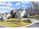 Two-story home with a combination of white and black siding, a three-car garage, and a well-manicured lawn at 4835 Fields Bridge Rd, Cumming, GA 30028