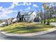 A modern two-story home on a manicured lawn, with a basketball court on the driveway at 4835 Fields Bridge Rd, Cumming, GA 30028