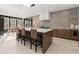 Spacious kitchen featuring large island with seating and designer tile backsplash at 4835 Fields Bridge Rd, Cumming, GA 30028