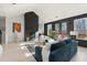 Bright open concept living room features fireplace, hardwood floors, and access to back deck at 4835 Fields Bridge Rd, Cumming, GA 30028