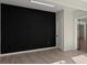 Modern living space with bold black accent wall and wood flooring at 4835 Fields Bridge Rd, Cumming, GA 30028
