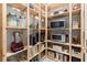Walk-in pantry with open wooden shelves and stocked with food and small appliances at 4835 Fields Bridge Rd, Cumming, GA 30028
