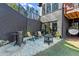 Charming outdoor patio with a fire pit, grill, lounge chairs, and a hanging chair for relaxation at 4835 Fields Bridge Rd, Cumming, GA 30028