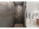 Contemporary shower featuring stone tile, modern fixtures, and glass enclosure at 4835 Fields Bridge Rd, Cumming, GA 30028