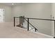 Modern staircase featuring black railings and light hardwood floors, offering a sleek transition between levels at 4835 Fields Bridge Rd, Cumming, GA 30028