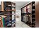 Walk-in closet with custom shelves, clothing racks, and a view into the bathroom at 4835 Fields Bridge Rd, Cumming, GA 30028