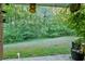 Backyard view with lush greenery, tree line, and potential for landscaping at 6351 Wedgeview Ct, Tucker, GA 30084