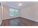 Bedroom featuring hard surface floors and a window offering natural light at 6351 Wedgeview Ct, Tucker, GA 30084