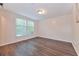 Bedroom showcasing natural light from a large window and hard surface floors at 6351 Wedgeview Ct, Tucker, GA 30084