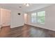 Bright bedroom with hard surface floors, a large window, and easy access to the bathroom at 6351 Wedgeview Ct, Tucker, GA 30084