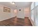 Bedroom featuring hard surface floors with a large window, bathroom, and closet access at 6351 Wedgeview Ct, Tucker, GA 30084