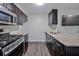 Modern kitchen with granite countertops, stainless steel appliances, and dark wood cabinets at 6351 Wedgeview Ct, Tucker, GA 30084