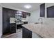 Bright kitchen features granite counters, stainless steel appliances, and dark wood cabinetry at 6351 Wedgeview Ct, Tucker, GA 30084