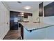 Well-lit kitchen with granite counters, stainless appliances, and dark wood cabinets at 6351 Wedgeview Ct, Tucker, GA 30084