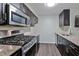 Well-lit kitchen with stainless steel appliances and granite countertops at 6351 Wedgeview Ct, Tucker, GA 30084