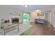 Bright living room featuring a fireplace, sliding glass doors, and hardwood flooring at 6351 Wedgeview Ct, Tucker, GA 30084