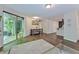 Open living room featuring sliding glass door, hardwood floors, and access to kitchen at 6351 Wedgeview Ct, Tucker, GA 30084