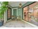 A cozy outdoor patio has chairs, table, plants, and sliding door with a kitchen view at 6351 Wedgeview Ct, Tucker, GA 30084