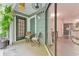 A cozy outdoor patio with chairs, table, plants, and sliding door with a kitchen view at 6351 Wedgeview Ct, Tucker, GA 30084