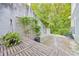 The side yard has an outdoor table and landscaping along a privacy wall at 6351 Wedgeview Ct, Tucker, GA 30084