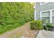 A view of the side yard of the home, showing the green lawn and landscaping at 6351 Wedgeview Ct, Tucker, GA 30084