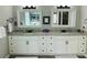 Bathroom with double sink vanity featuring granite countertops and modern lighting at 9030 Brockham Way, Johns Creek, GA 30022