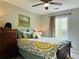 Bright bedroom with decorative pillows, a ceiling fan, and an accent painting at 9030 Brockham Way, Johns Creek, GA 30022