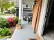 Cozy front porch with brick accents, decorative plants, and outdoor seating, creating a welcoming entrance at 9030 Brockham Way, Johns Creek, GA 30022