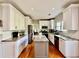 Bright kitchen with granite countertops, modern appliances, and an island, creating an appealing cooking space at 9030 Brockham Way, Johns Creek, GA 30022