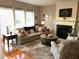 Cozy living room with plush seating, fireplace, and natural light from large windows at 9030 Brockham Way, Johns Creek, GA 30022