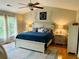 Serene main bedroom with a king bed, ceiling fan, and natural light from the windows at 9030 Brockham Way, Johns Creek, GA 30022