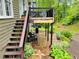 Inviting stone patio with comfortable seating, a staircase to a deck, and landscaped garden areas at 9030 Brockham Way, Johns Creek, GA 30022