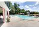Large community pool featuring lounge chairs, umbrellas, and shaded seating areas at 9030 Brockham Way, Johns Creek, GA 30022