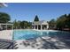 Community pool featuring a cabana, lounge chairs, and a pergola seating area at 9030 Brockham Way, Johns Creek, GA 30022