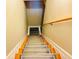 Clean stairway with carpet runner and wooden handrail, and white risers at 9030 Brockham Way, Johns Creek, GA 30022