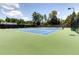 Outdoor tennis courts featuring well-maintained surfaces and ample lighting at 9030 Brockham Way, Johns Creek, GA 30022