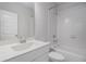 Modern bathroom with tiled bathtub and shower, a large vanity, and new fixtures at 2026 Manchester Ne St, Atlanta, GA 30324