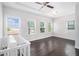 Bright bedroom featuring hardwood floors, natural light from windows, and a modern ceiling fan at 2026 Manchester Ne St, Atlanta, GA 30324