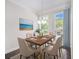 Dining room featuring wood floors, modern chandelier, large windows, and a tastefully decorated table at 2026 Manchester Ne St, Atlanta, GA 30324