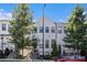 Charming two-story townhome with a grey exterior, black framed windows and landscaped front yard at 2026 Manchester Ne St, Atlanta, GA 30324