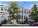 Charming townhome featuring a well-manicured lawn, brick accents, and classic architectural details at 2026 Manchester Ne St, Atlanta, GA 30324