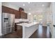 Bright kitchen with a large center island, stainless steel refrigerator, and modern finishes at 2026 Manchester Ne St, Atlanta, GA 30324