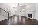 Bright living room featuring a fireplace, gleaming hardwood floors, and large windows at 2026 Manchester Ne St, Atlanta, GA 30324