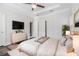 Cozy primary bedroom with decor, ceiling fan, hardwood floors, and ensuite bathroom access at 2026 Manchester Ne St, Atlanta, GA 30324